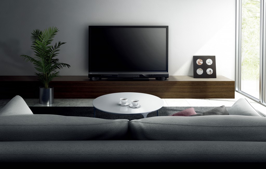 The Yamaha YSP-1400, discreetly nestled underneath a flat screen TV.
