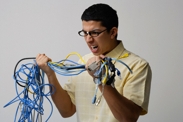 Frustrated man with tangled wires
